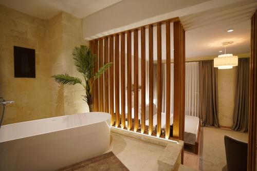 a bathroom with a tub and a large window at Gülten Hanım Konağı in Gaziantep