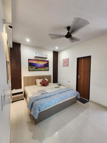 a bedroom with a bed and a ceiling fan at Shivara Homes in Jaipur