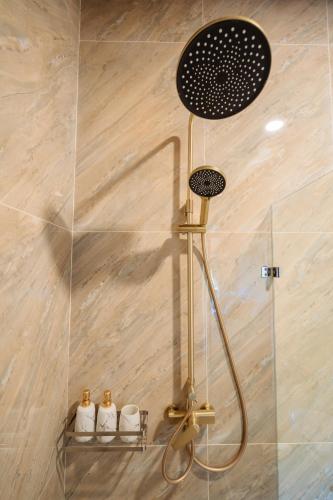 a shower in a bathroom with a glass wall at Club Bamboo Boutique Patong Beach Resort in Patong Beach