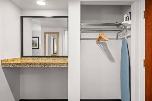 a bathroom with a mirror and a sink at Big Horn Resort, an Ascend Collection Hotel in Billings