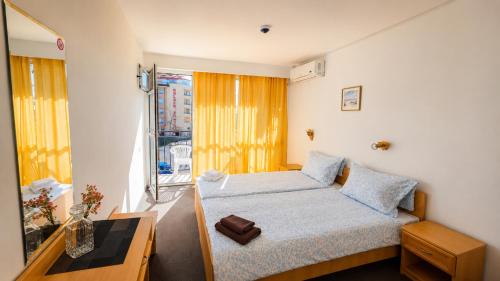 a small bedroom with a bed and a window at Sunny Steps Hostel in Sunny Beach