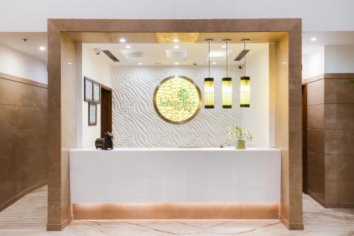 a lobby with a sign on a wall at Lemon Tree Hotel, Sector 60, Gurugram in Gurgaon