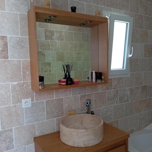 a bathroom with a sink and a mirror at Chez Nathalie in Le Luc