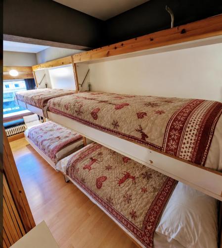 a group of bunk beds in a room at "FamilyNest" by Staymarilleva1400 in Marilleva