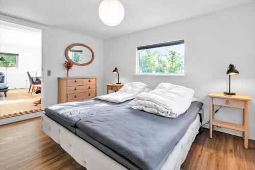 a bedroom with a bed and a dresser and a mirror at 14231-1-Grevinge-Kirsebaerhaven-18 in Grevinge