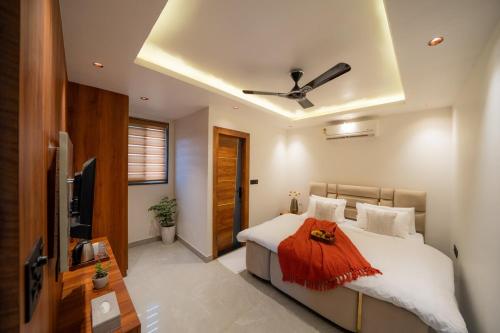 a bedroom with a bed and a ceiling fan at Water by The StayCationer in Dehradun