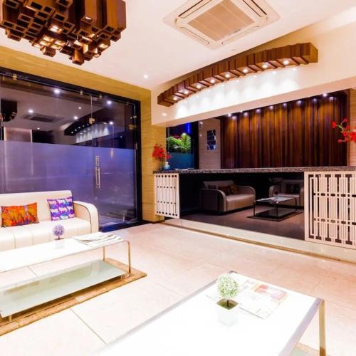 a living room with a couch and a table at Hotel Rockland Kota in Kota