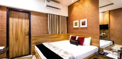 a bedroom with a large bed in a room at Hotel Rockland Kota in Kota