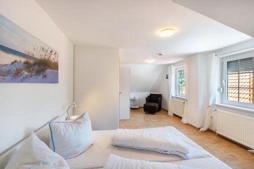 a bedroom with a bed and a living room at Ferienwohnung Glück In Dornum in Dornum