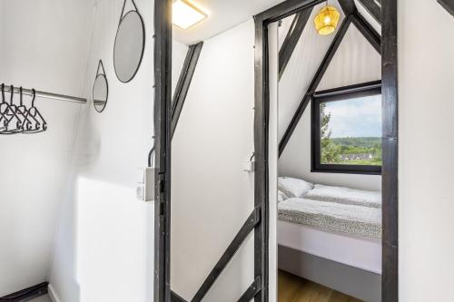 a room with a window and a bed in it at Tiny House Trudi mit Garten in Bad Wünnenberg