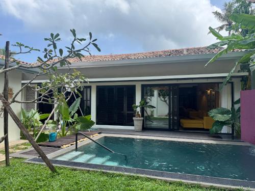 a house with a swimming pool in the yard at Palace Bope Galle in Galle