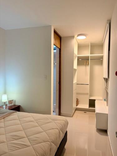a bedroom with a bed and a walk in closet at CasaLoop in Ica