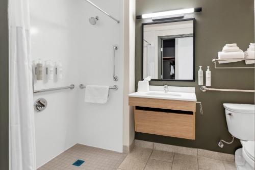 a bathroom with a sink and a toilet and a mirror at Spark By Hilton Akron Fairlawn in Fairlawn