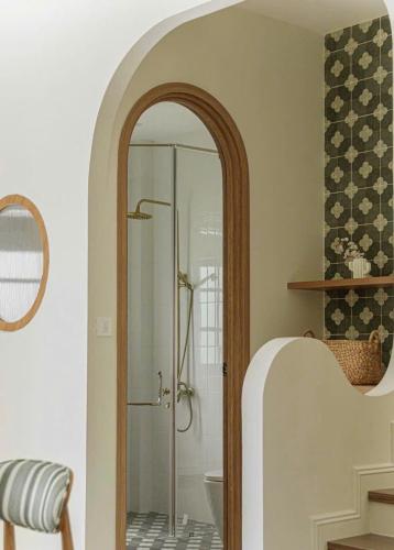 a bathroom with a shower with a glass door at VILLA NOVAWORLD PHAN THIET Beach in Phan Thiet