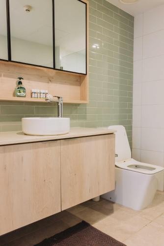 a bathroom with a sink and a toilet at 201 - Ocean Views Oceanfront Large Balcony in Suva