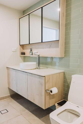 a bathroom with a sink and a toilet at 202 - Ocean Views Oceanfront Large Balcony in Suva