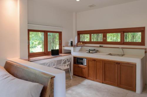 a kitchen with a sink and a counter top at Boonya Swiss Home in Chaloklum