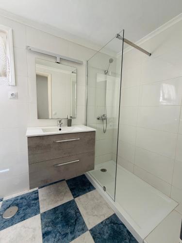 a bathroom with a sink and a glass shower at Casa TIN TIN Lanzarote in Tías