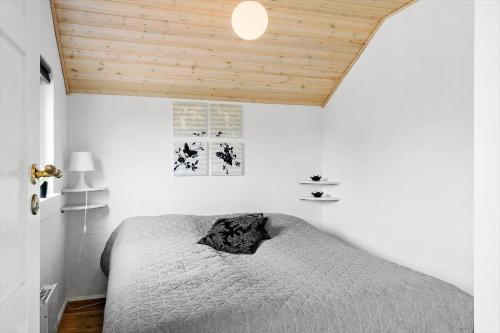 a bedroom with a bed and a wooden ceiling at LF12172-Vinderup-Strandlyst-29 in Vinderup
