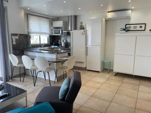 a kitchen and dining room with a table and chairs at Palais Rouaze in Cannes
