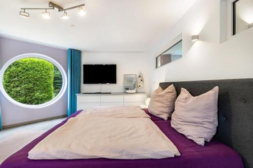 a bedroom with a large bed and a window at Casa Wohnen und Wellness in Hemer