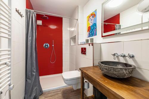 a bathroom with a sink and a toilet at Casa Wohnen und Wellness in Hemer