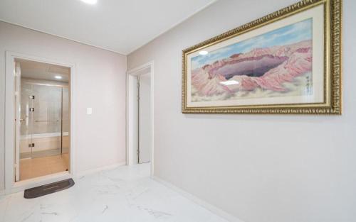 a white room with a painting on the wall at Y2 Stay Hotel in Sokcho