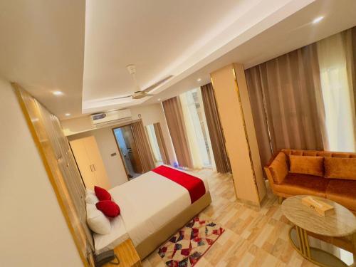 a hotel room with a bed and a couch at Arham Beach Resort in Cox's Bazar