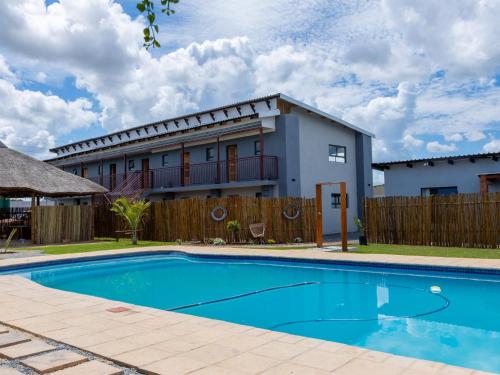 a house with a swimming pool in front of a house at Tlatso lifestyle and Accommodation in Hammanskraal Station