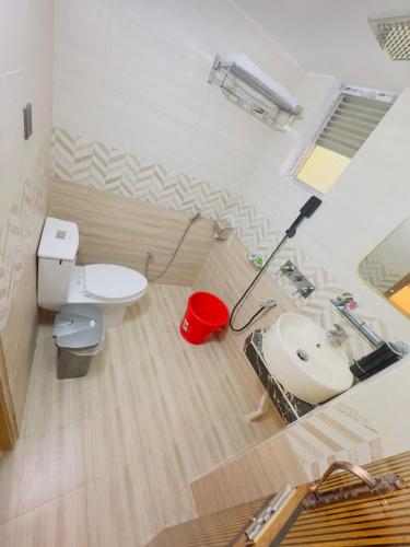 a bathroom with a toilet and a sink at Arham Beach Resort in Cox's Bazar
