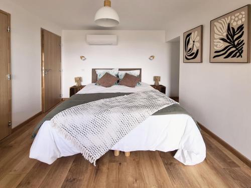 a bedroom with a large bed with white sheets at Le Vernay en Savoie - Petit Hôtel Nature in Saint-Maurice-de-Rotherens