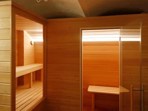 a sauna with wood paneling and a glass door at Ferienwohnung Bieber in Seiffen