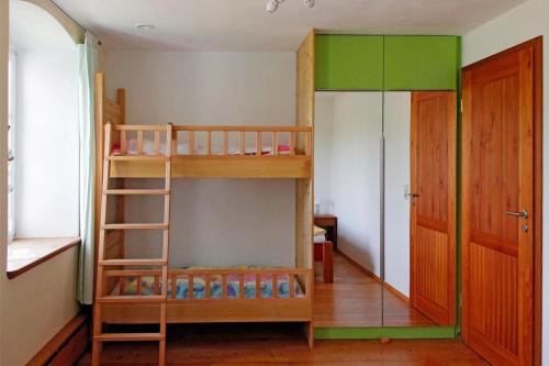a room with two bunk beds and a ladder at Ferienwohnung Bieber in Seiffen
