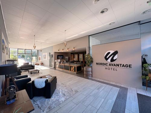 a lobby of a mobile appliance hotel with a couch and chairs at Nordic Avantage Hotel in Kiel