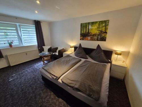 a hotel room with a bed and a living room at Neu!!! Pension Scherz-ruhig am Standrand mit Wasserzugang & Paddelboot in Lübbenau