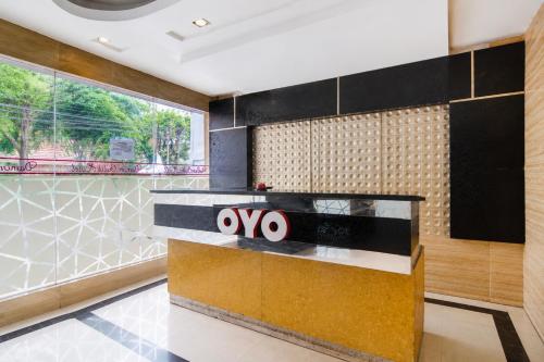 a lobby with a counter with a large window at Hotel O near RSUD Arifin Achmad formerly Damon Butik Hotel in Limbangan