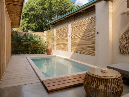 a small swimming pool in a patio with a table at HAMA Villa with private pool in El Nido