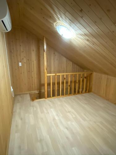 a room with a bed in a wooden house at 신화펜션 in Koryŏng