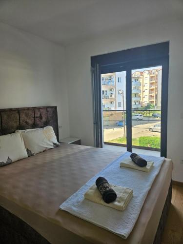 a bedroom with a bed with two towels on it at Apartman Marija IV in Vrnjačka Banja