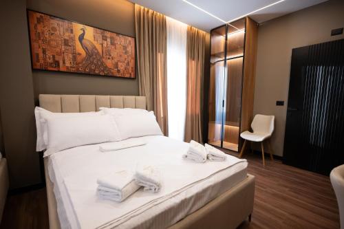 a hotel room with a bed with towels on it at 2S Vila Boutique Pogradec in Pogradec