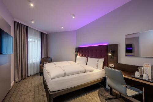 a bedroom with a large white bed and a desk at Premier Inn Koblenz City in Koblenz