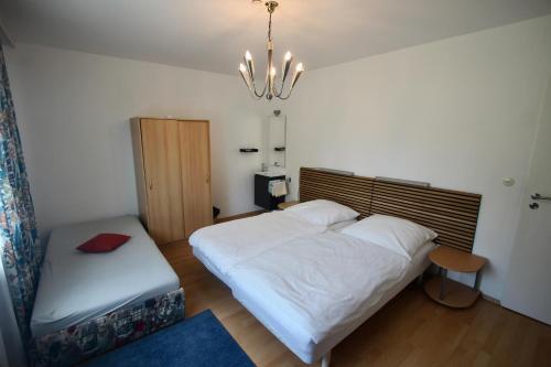 a bedroom with a bed and a bench in it at Haus die Gerti - Ilz in Waldkirchen
