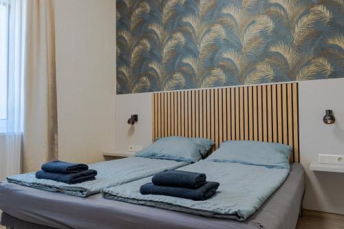a bedroom with two beds with blue towels on them at Luca Villa in Balatonlelle