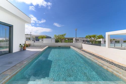 a swimming pool in the backyard of a house at Vila Adelino in Sines