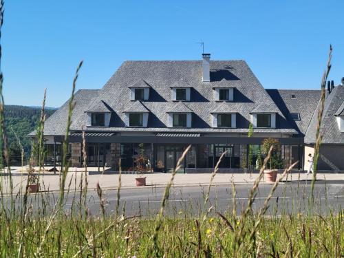 a large building with a gambrel roof at Le Panoramic Garabit in Anglards-de-Saint-Flour