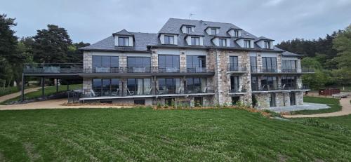 a large house with a large yard in front of it at Le Panoramic Garabit in Anglards-de-Saint-Flour