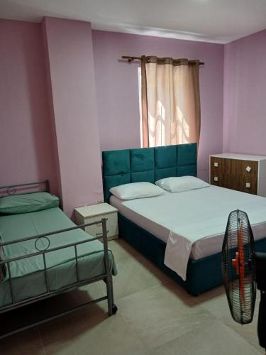 a bedroom with two beds and a window at SeaSideGolem Apartments in Golem
