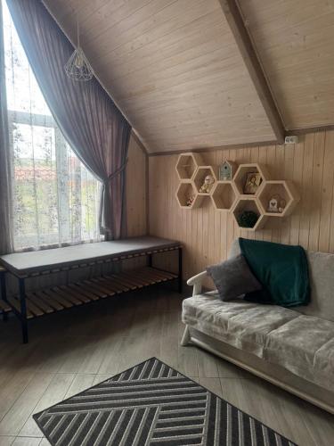 a living room with a couch and a window at Медовий сон in Pasichna