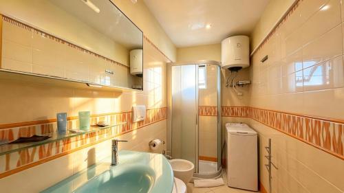 a bathroom with a sink and a toilet and a shower at Vista Mare a Isola Verde in Isola Bacucco