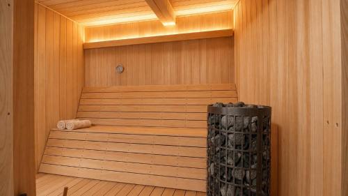 a wooden sauna with a wooden floor and a tub at Villa KULM in Minamiawaji